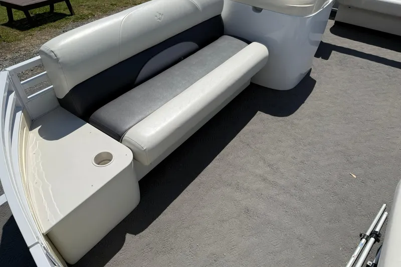 Slide: The Image of 2010 JC 21 Neptoon boat interior with gray and white seating and cup holder. - 9