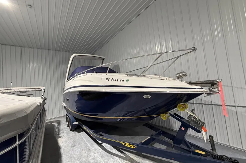 The Image of 2012 Regal 28 Express boat on trailer in storage facility. - 1