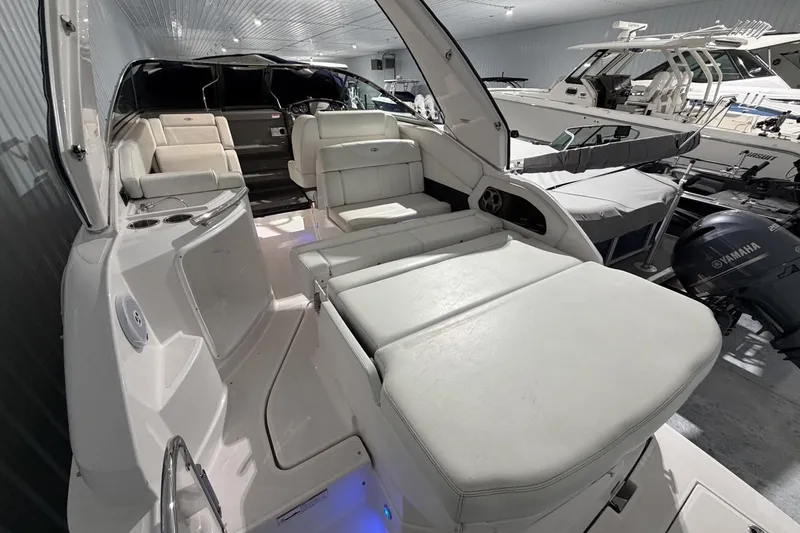 Slide: The Image of 2012 Regal 28 Express boat interior with white seating in a showroom. - 10