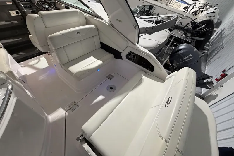 Slide: The Image of Interior of a 2012 Regal 28 Express boat with white seating and Yamaha engines. - 12
