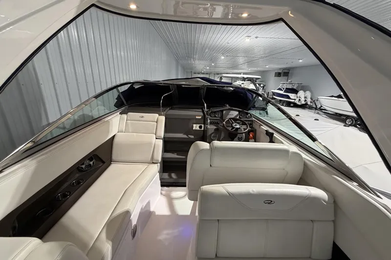 Slide: The Image of Interior of a 2012 Regal 28 Express boat with white seating and modern dashboard. - 13