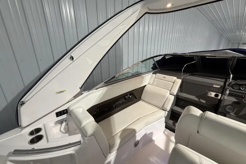 Slide: The Image of Interior view of a 2012 Regal 28 Express boat with white seating and dashboard. - 14