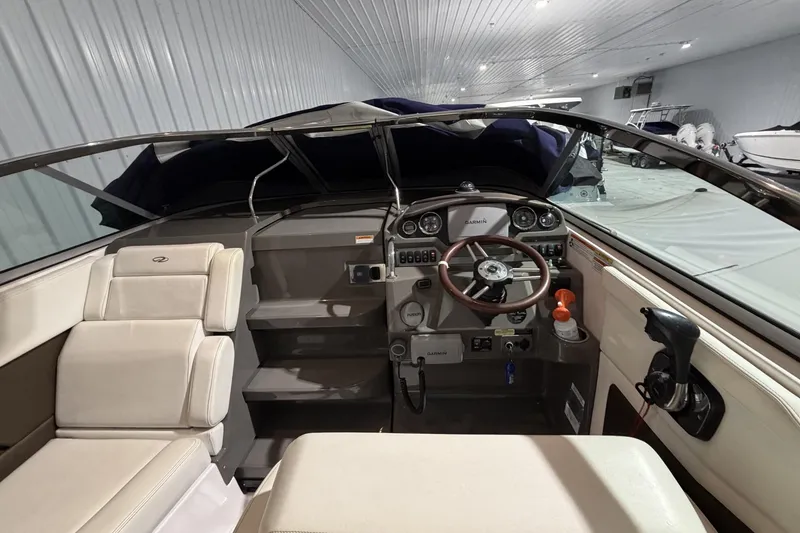 Slide: The Image of Interior view of a 2012 Regal 28 Express boat cockpit with steering wheel and controls. - 15