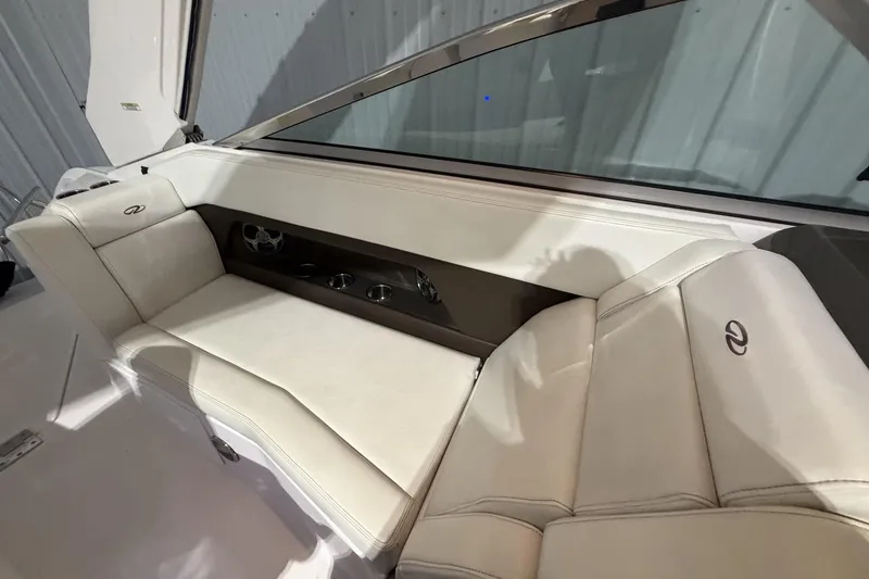Slide: The Image of Interior seating of a 2012 Regal 28 Express boat, featuring white leather upholstery. - 18