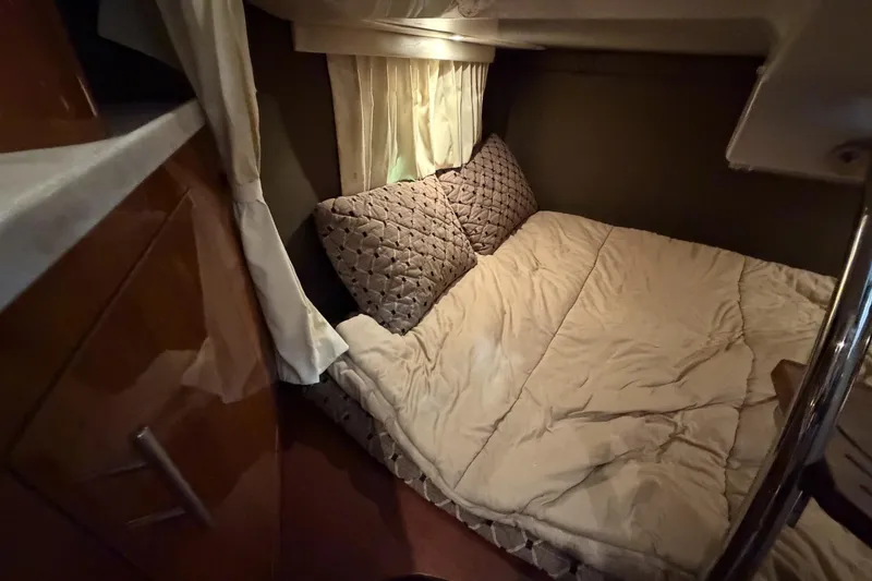 Slide: The Image of Cozy cabin interior of 2012 Regal 28 Express boat with bed and curtains. - 26