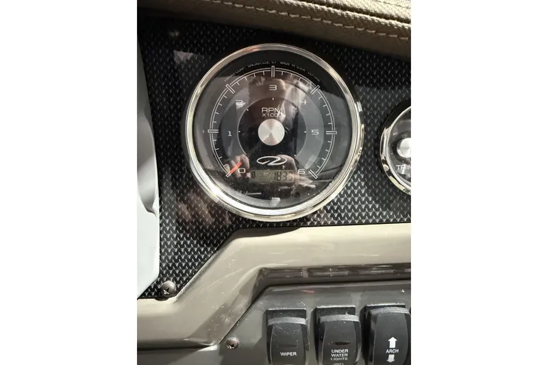 Slide: The Image of Close-up of 2012 Regal 28 Express boat dashboard with RPM gauge and switches. - 30