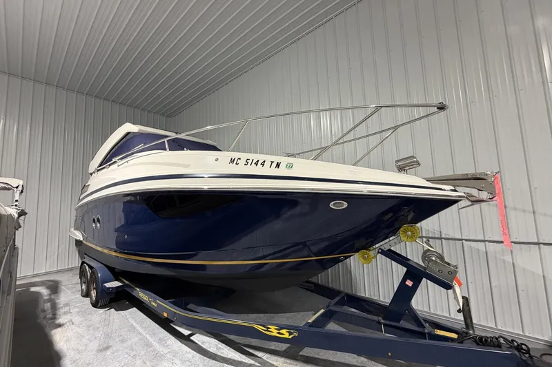 Slide: The Image of 2012 Regal 28 Express boat on trailer in storage facility. - 31