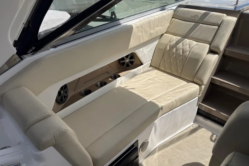 Slide: The Image of Luxurious seating on 2018 Regal 28 Express boat with beige upholstery and cup holders. - 13