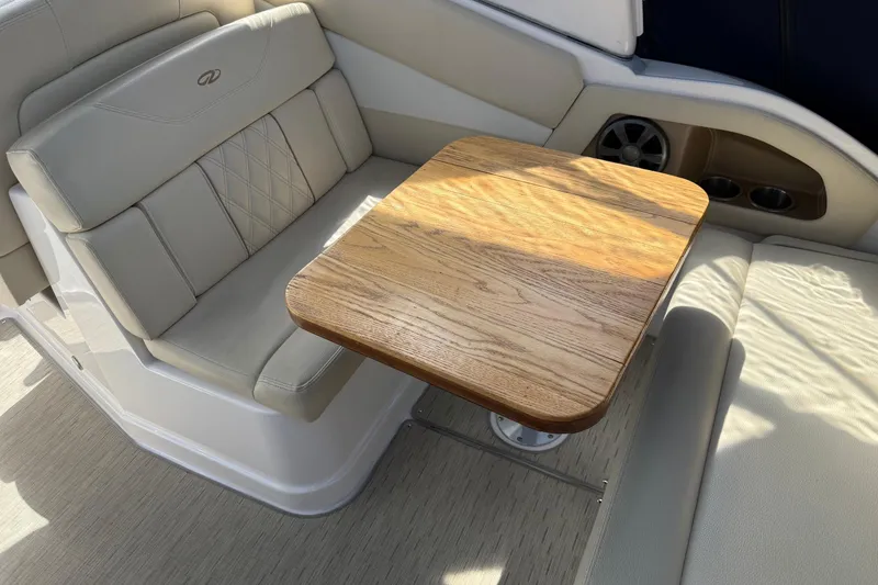 Slide: The Image of Luxurious seating area with wooden table on 2018 Regal 28 Express boat. - 14