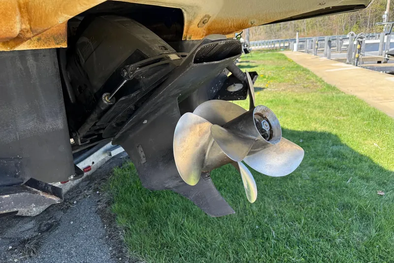 Slide: The Image of 2018 Regal 28 Express boat propeller on grass near a dock. - 3
