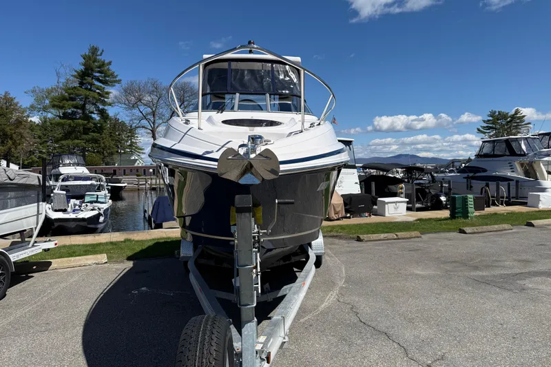 Slide: The Image of 2018 Regal 28 Express boat on trailer at marina, clear sky background. - 6