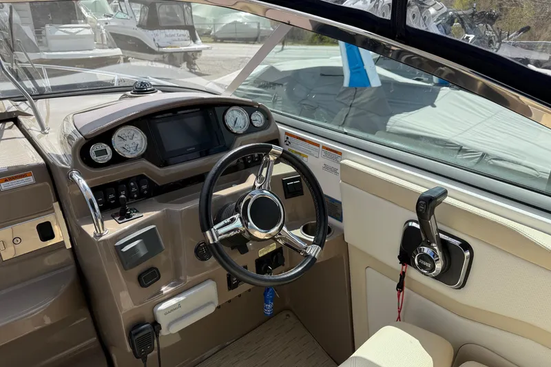 Slide: The Image of Cockpit of 2018 Regal 28 Express boat with steering wheel and control panel. - 8