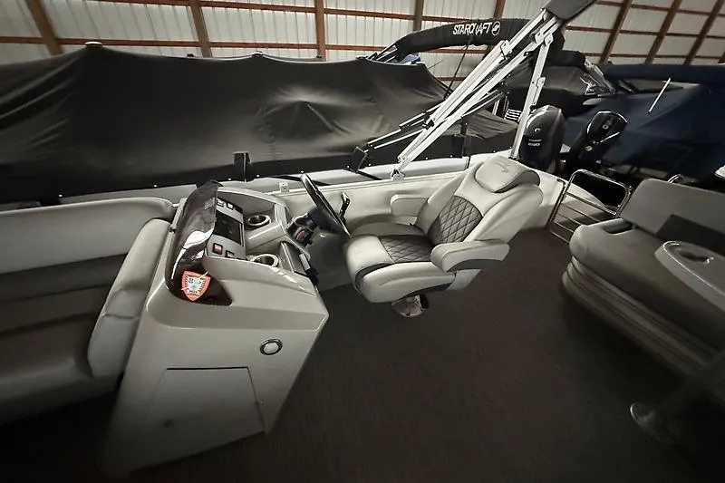 Slide: The Image of 2021 Bennington 25 SSBXSD boat interior with steering console and seating. - 15