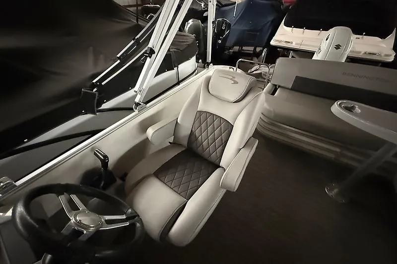 Slide: The Image of Luxurious interior of 2021 Bennington 25 SSBXSD boat with plush seating and steering wheel. - 17