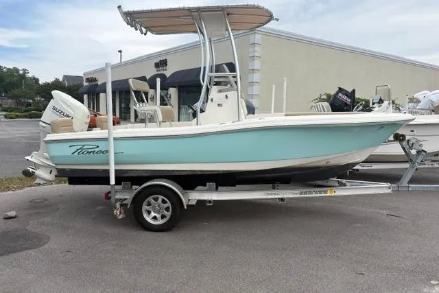 The Image of 2020 Pioneer 180 Islander boat on trailer, light blue hull, parked outdoors. - 1