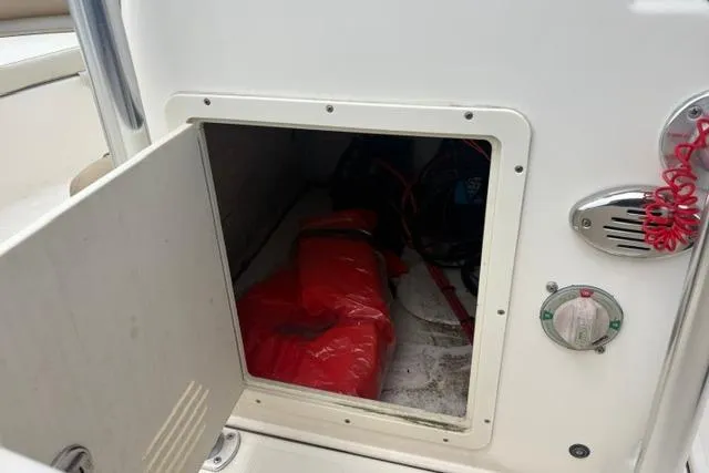 Slide: The Image of Storage compartment on a 2020 Pioneer 180 Islander boat, featuring safety equipment. - 10