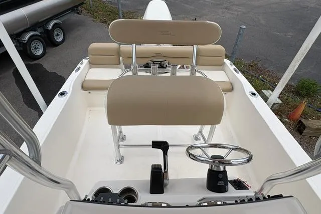 Slide: The Image of 2020 Pioneer 180 Islander boat interior with beige seating and steering console. - 11