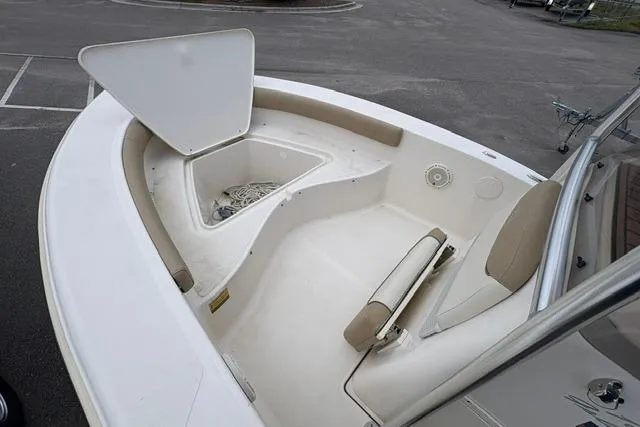 Slide: The Image of 2020 Pioneer 180 Islander boat interior with open storage compartment and seating. - 8