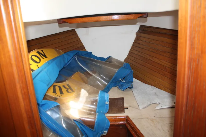Slide: The Image of Interior of 1983 Cape Dory 27 sailboat with wooden paneling and stored equipment. - 18