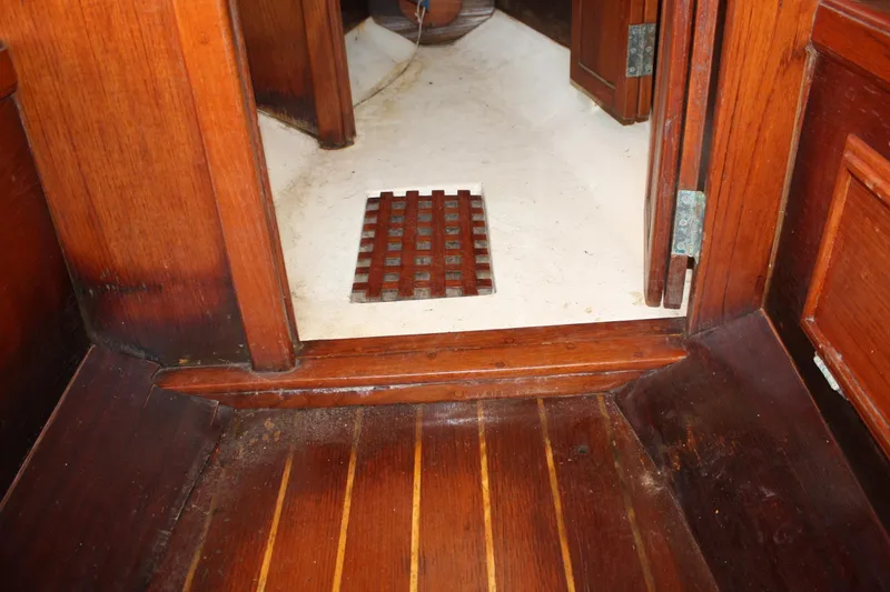 Slide: The Image of Interior of 1983 Cape Dory 27 sailboat with wooden flooring and cabin entrance. - 25