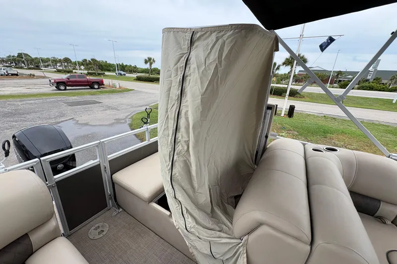 Slide: The Image of 2023 Sun Tracker Party Barge 22 DLX interior with seating and privacy curtain. - 11