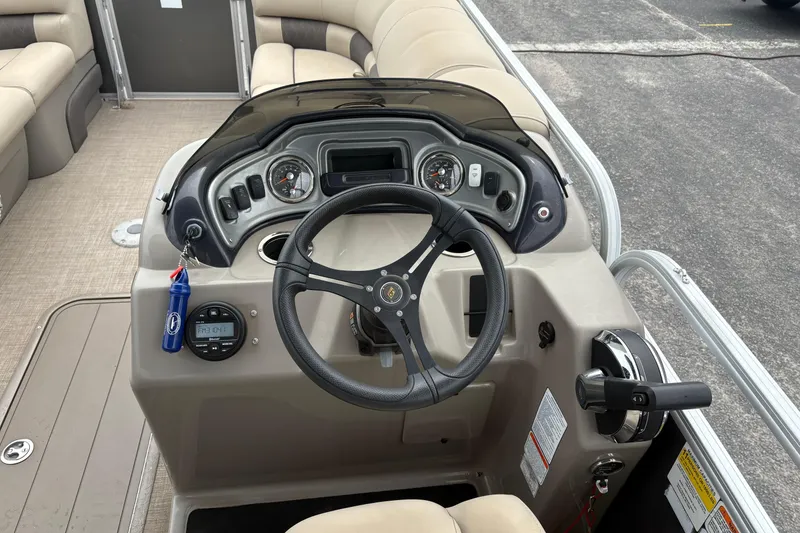 Slide: The Image of 2023 Sun Tracker Party Barge 22 DLX steering console with gauges and controls. - 13