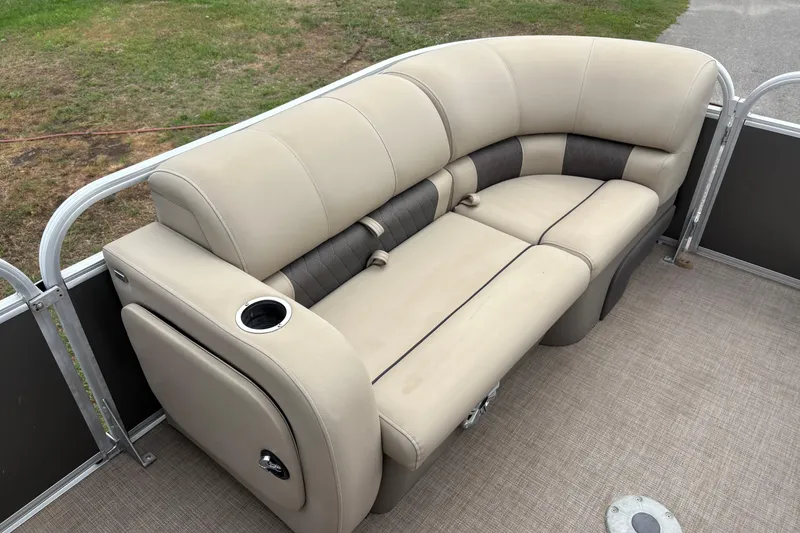 Slide: The Image of 2023 Sun Tracker Party Barge 22 DLX, featuring beige cushioned seating with cup holder. - 18
