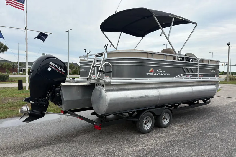 Slide: The Image of 2023 Sun Tracker Party Barge 22 DLX pontoon boat on trailer, with Mercury outboard motor. - 3