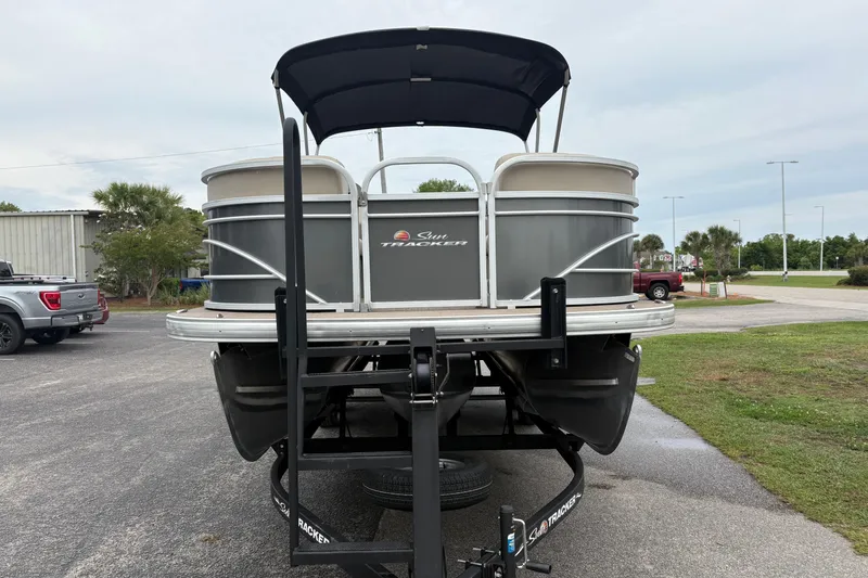 Slide: The Image of 2023 Sun Tracker Party Barge 22 DLX pontoon boat on trailer, parked outdoors. - 6