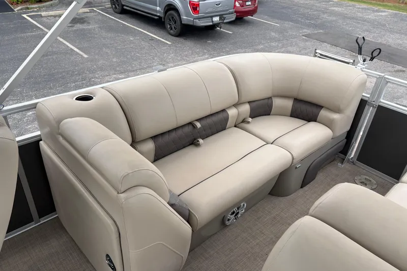Slide: The Image of 2023 Sun Tracker Party Barge 22 DLX with beige seating in a parking lot. - 9