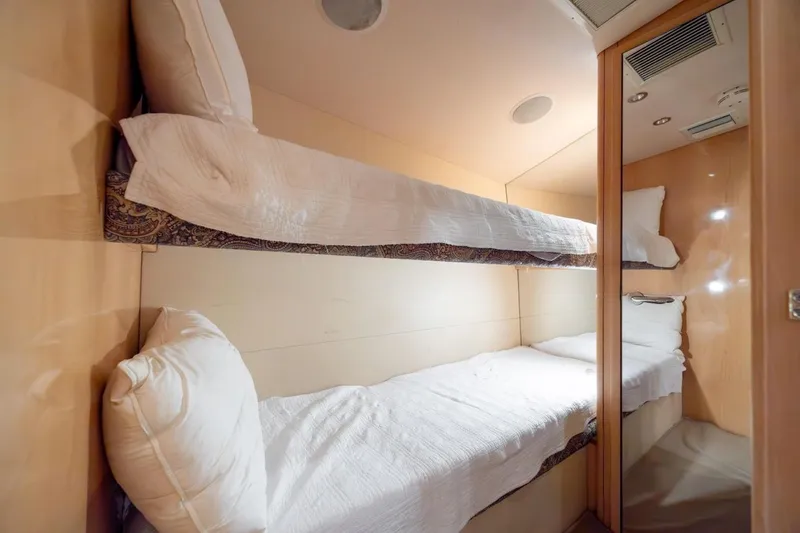 Slide: The Image of Bunk beds in 2003 Hatteras 60 Convertible yacht cabin, featuring wooden interior. - 11