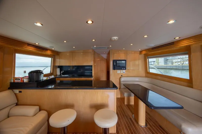 Slide: The Image of Luxurious interior of 2003 Hatteras 60 Convertible yacht with modern kitchen and seating area. - 12