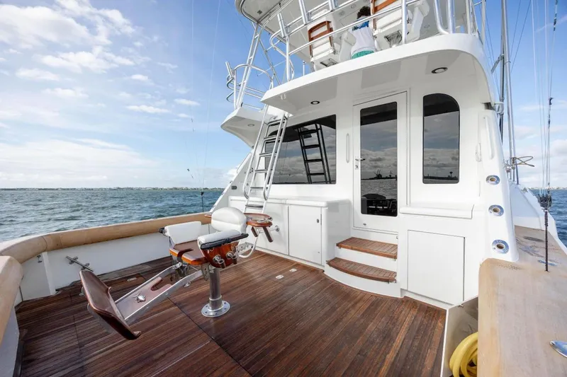 Slide: The Image of 2003 Hatteras 60 Convertible yacht deck with fishing chair and ocean view. - 18