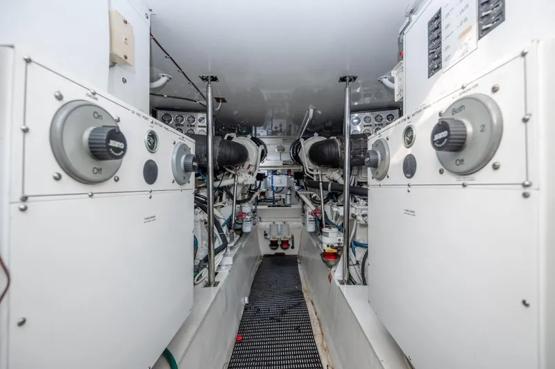 Slide: The Image of Engine room of 2003 Hatteras 60 Convertible yacht, showcasing mechanical systems and controls. - 19