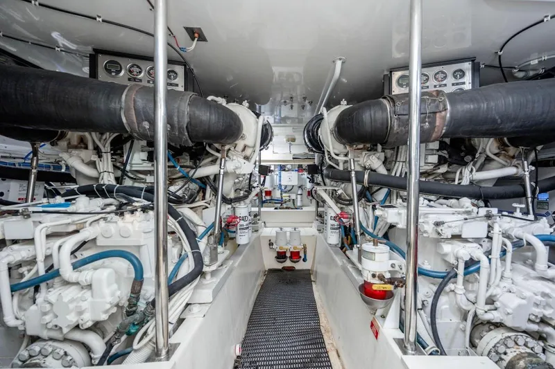 Slide: The Image of Engine room of 2003 Hatteras 60 Convertible yacht, showcasing dual engines and mechanical systems. - 21