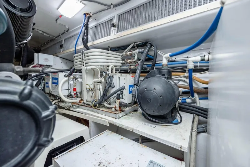 Slide: The Image of Engine room of 2003 Hatteras 60 Convertible yacht with mechanical equipment and piping. - 23