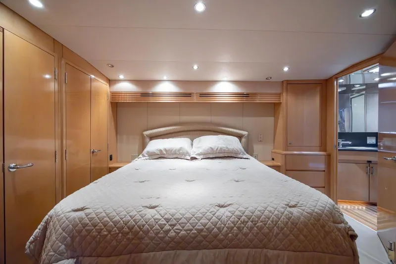 Slide: The Image of Luxurious bedroom interior of 2003 Hatteras 60 Convertible yacht with elegant wood finish. - 9