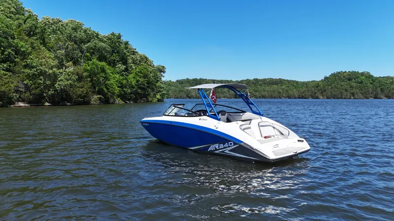 Slide: The Image of 2020 Yamaha Bow Rider boat on a serene lake. - 2