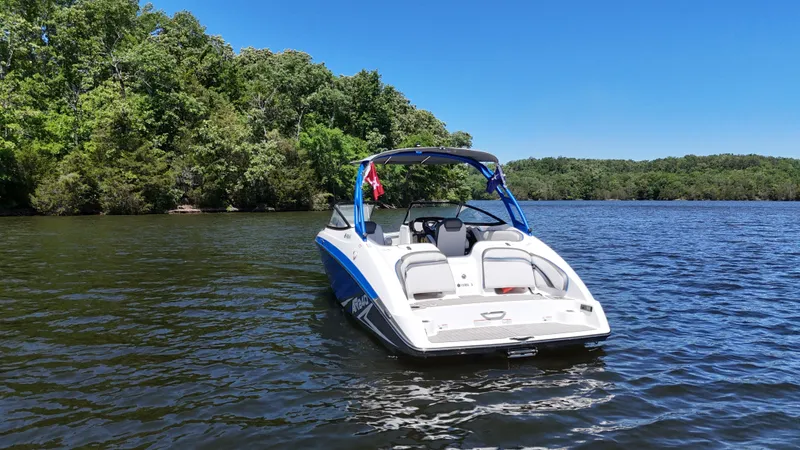 Slide: The Image of 2020 Yamaha Bow Rider boat on a serene lake. - 3