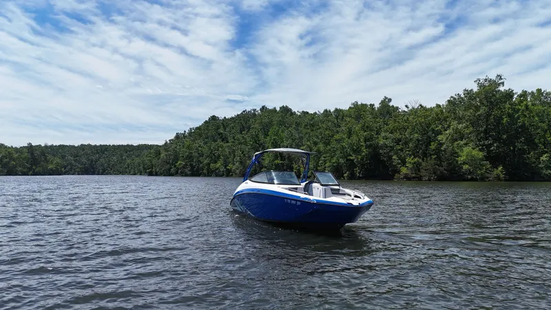 Slide: The Image of 2020 Yamaha Bow Rider on a serene lake with forested backdrop. - 5