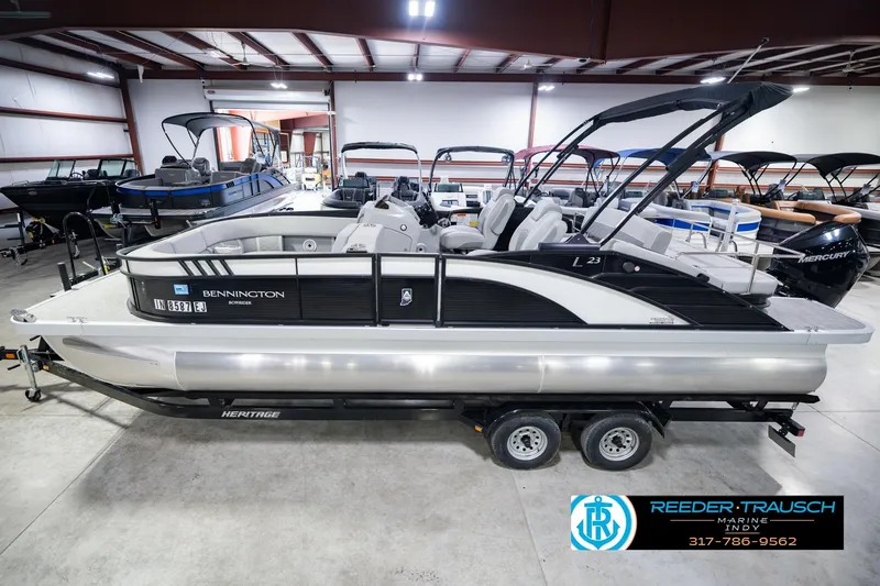 The Image of 2022 Bennington 23 LTSB pontoon boat in showroom, side view on trailer. - 0