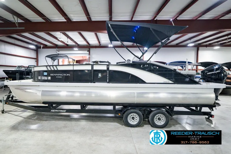Slide: The Image of 2022 Bennington 23 LTSB pontoon boat on trailer in indoor showroom. - 12