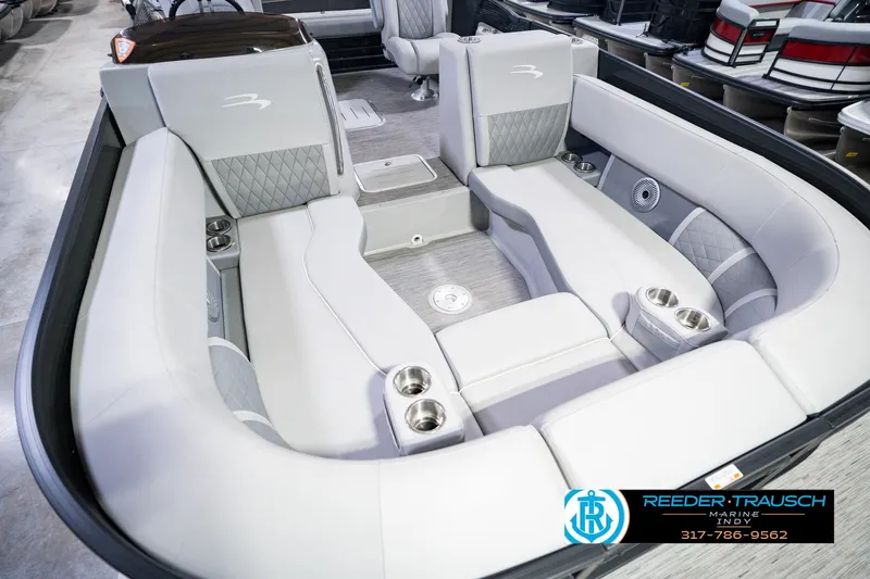 Slide: The Image of 2022 Bennington 23 LTSB boat interior with luxurious seating and cup holders. - 14