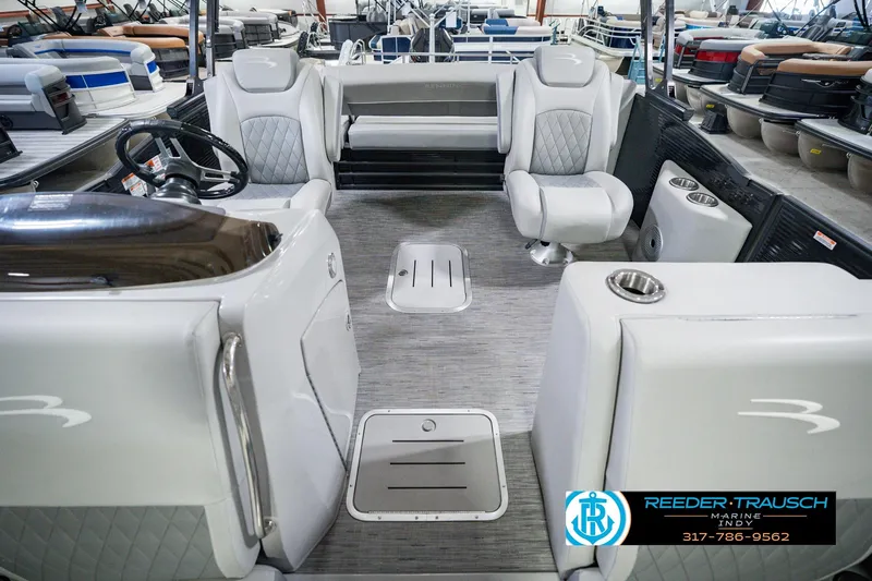 Slide: The Image of 2022 Bennington 23 LTSB pontoon boat interior with modern seating and steering wheel. - 20