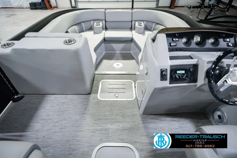 Slide: The Image of Interior of a 2022 Bennington 23 LTSB pontoon boat with modern seating and dashboard. - 24