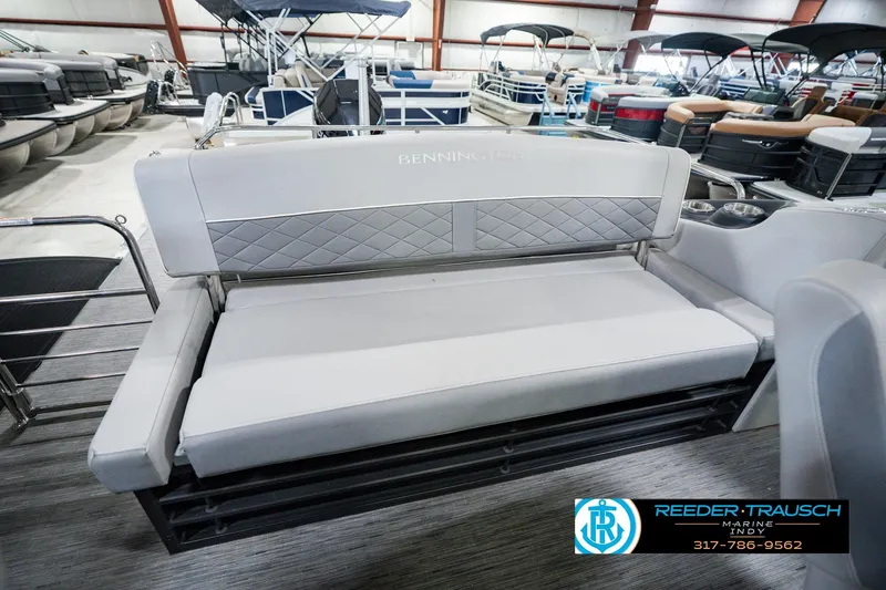 Slide: The Image of 2022 Bennington 23 LTSB pontoon boat interior with gray seating in showroom. - 32