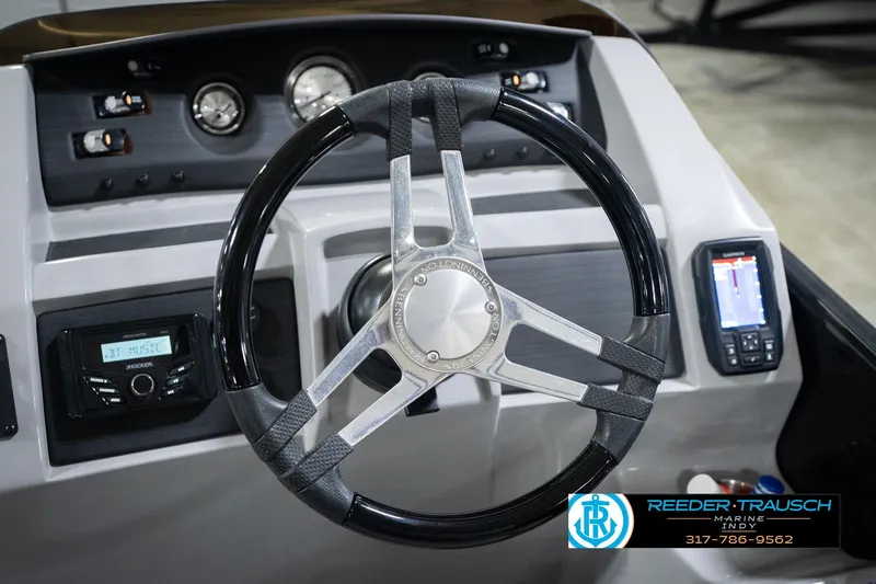 Slide: The Image of Steering wheel and dashboard of 2022 Bennington 23 LTSB boat with gauges and controls. - 39