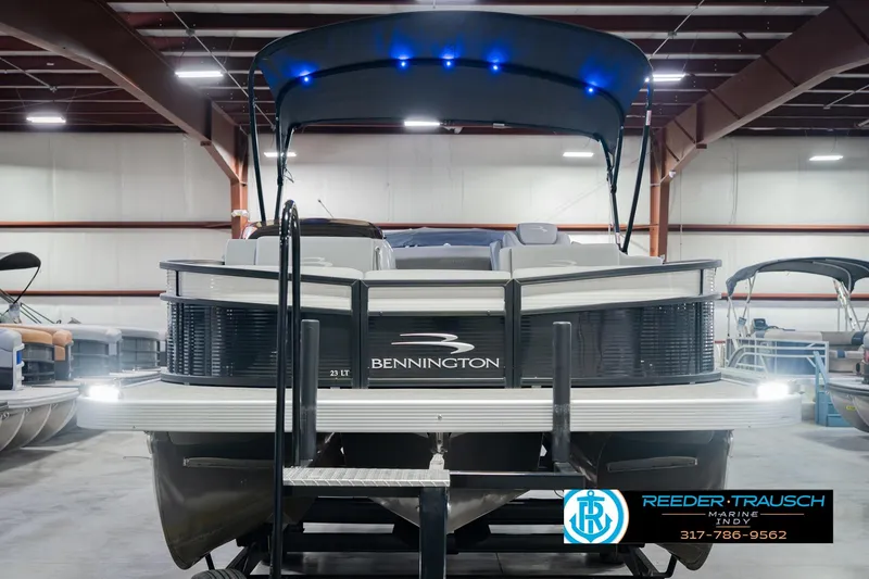 Slide: The Image of 2022 Bennington 23 LTSB pontoon boat in showroom with canopy and LED lights. - 4