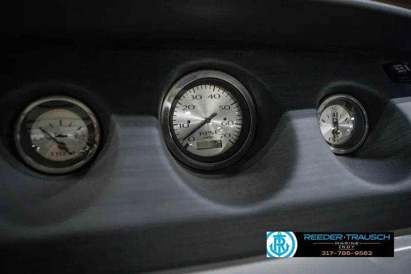 Slide: The Image of Dashboard gauges of a 2022 Bennington 23 LTSB boat, featuring RPM and fuel indicators. - 44
