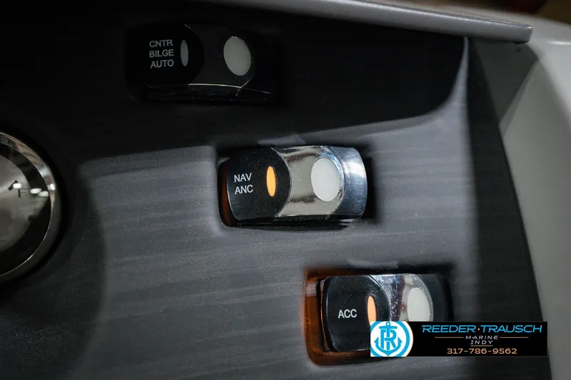 Slide: The Image of Dashboard switches on a 2022 Bennington 23 LTSB boat, featuring navigation and accessory controls. - 46